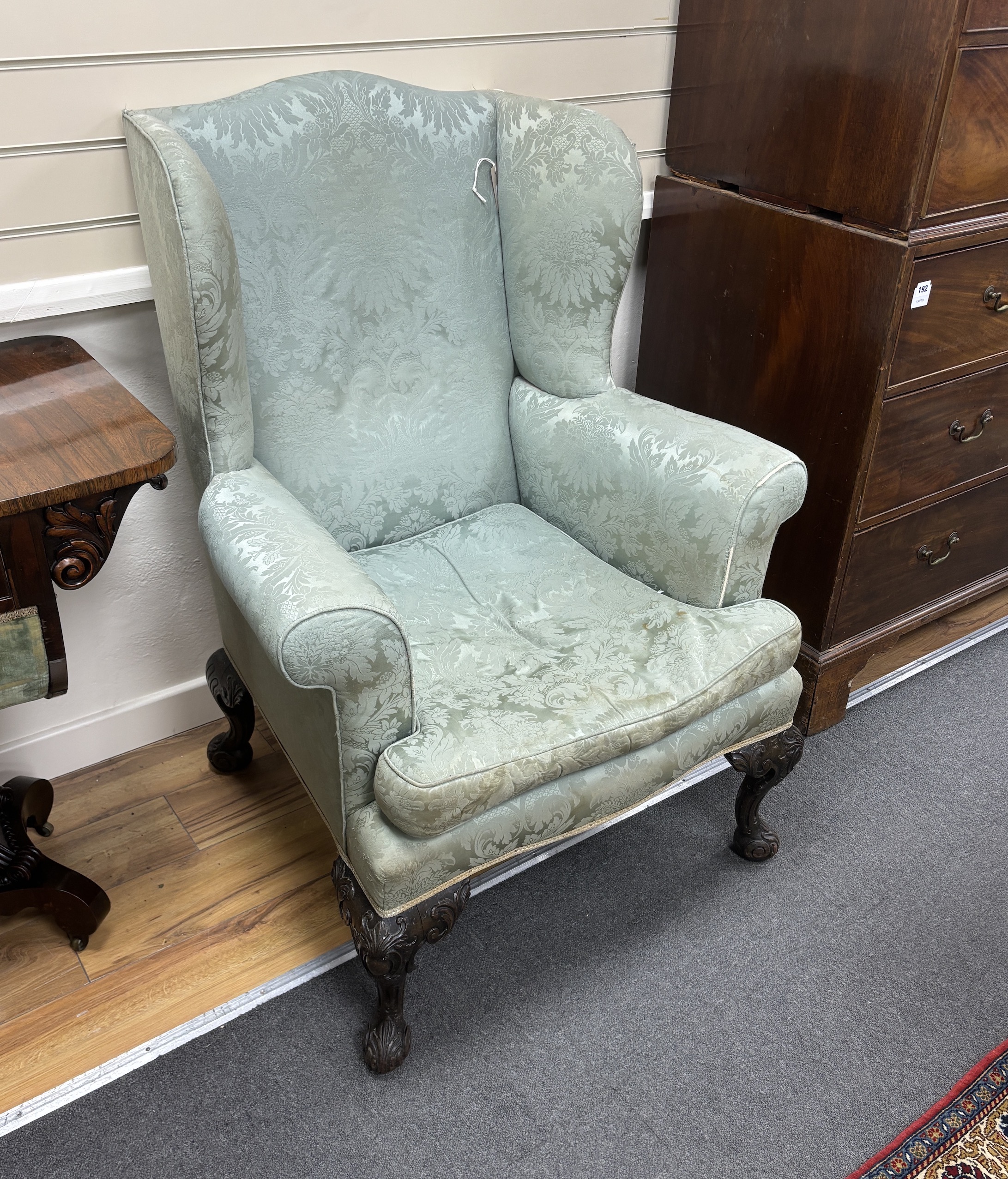 An early 20th century George III style upholstered wing armchair, width 82cm, depth 74cm, height 110cm